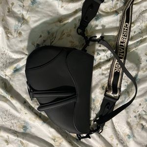 Not authentic Black saddle back with thick shoulder strap.